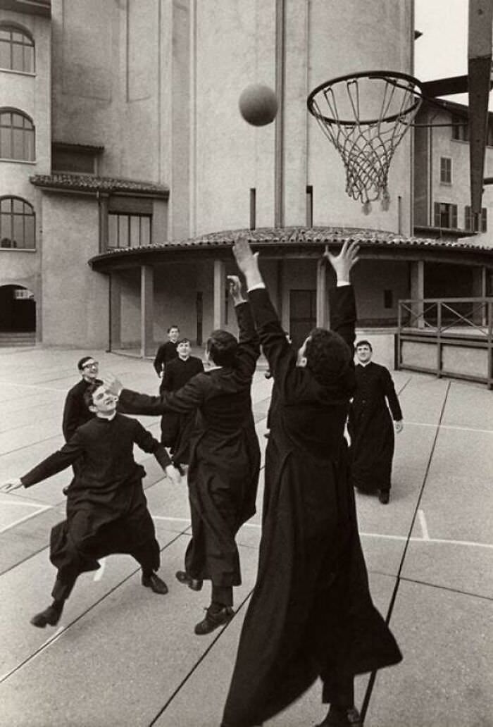 Catholic priests at a seminary playing a game of basketball, Bergamo, Italy, 1964.